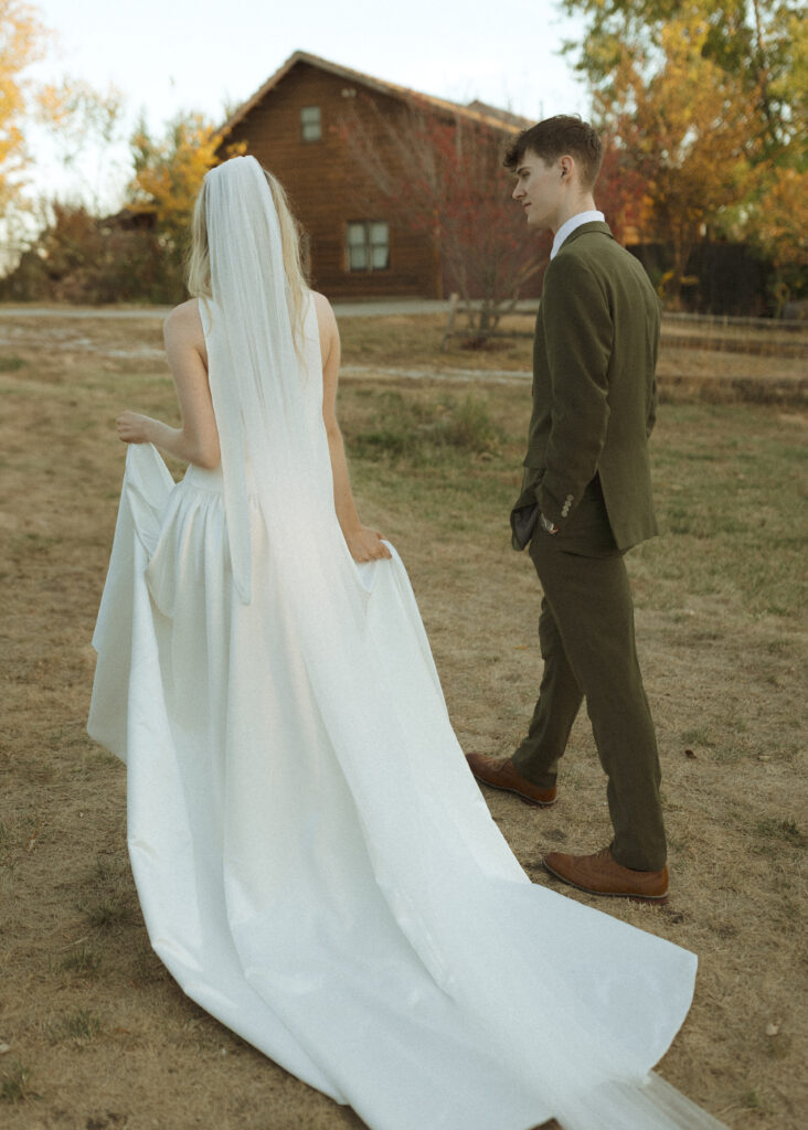 bride and groom taking photos for their Roca Ridge Events Wedding 