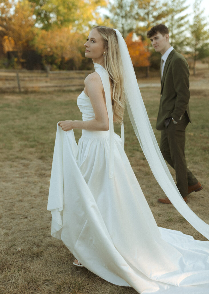 bride and groom taking photos for their Roca Ridge Events Wedding 