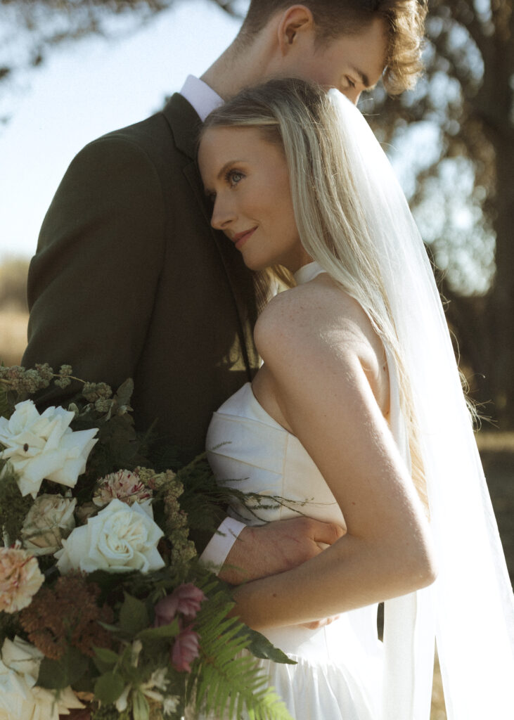 bride and groom taking photos for their Roca Ridge Events Wedding 