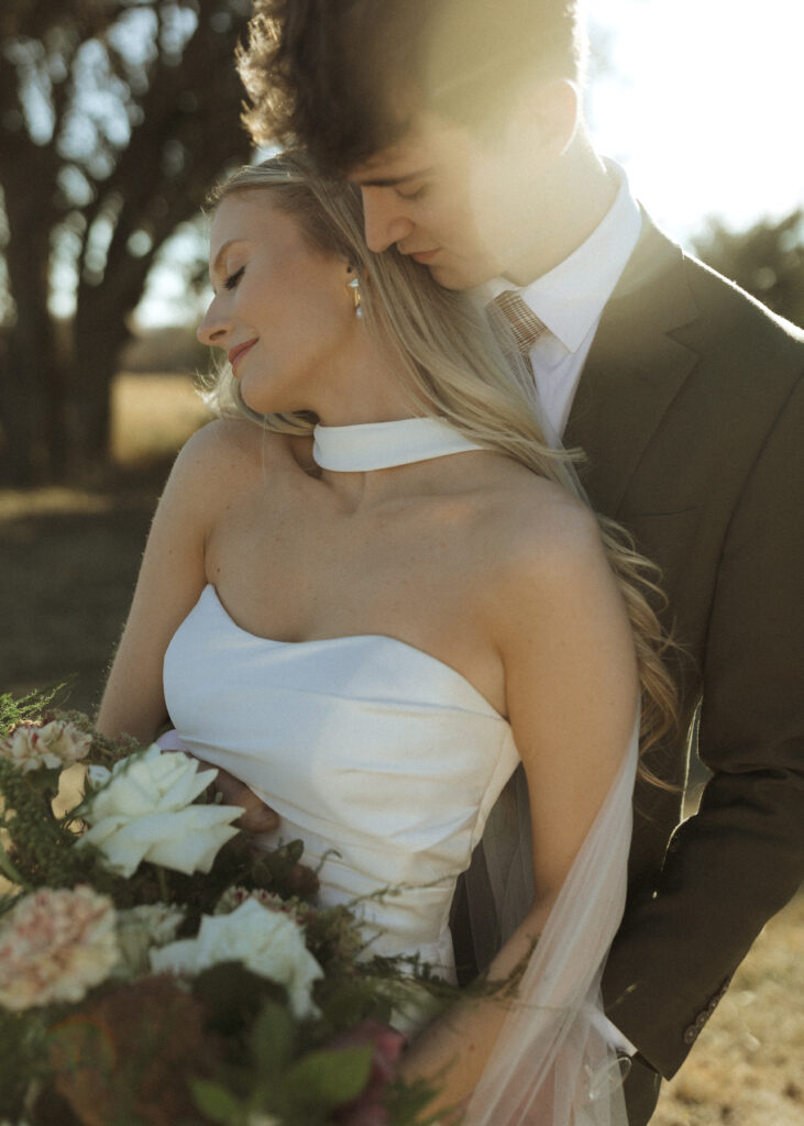 bride and groom taking photos for their Roca Ridge Events Wedding 