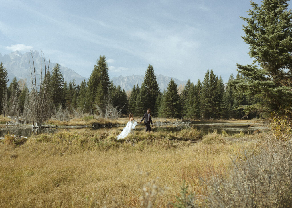 bride and groom taking wedding photos in grand teton national park 