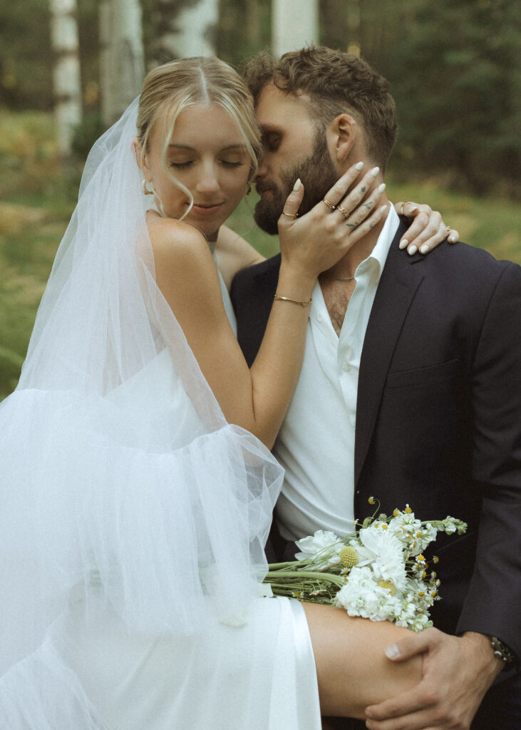 bride and groom taking wedding photos in the mountains 