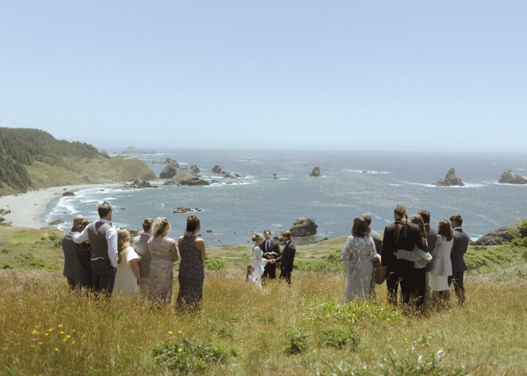 bride and groom getting married on the Oregon coast with their family 