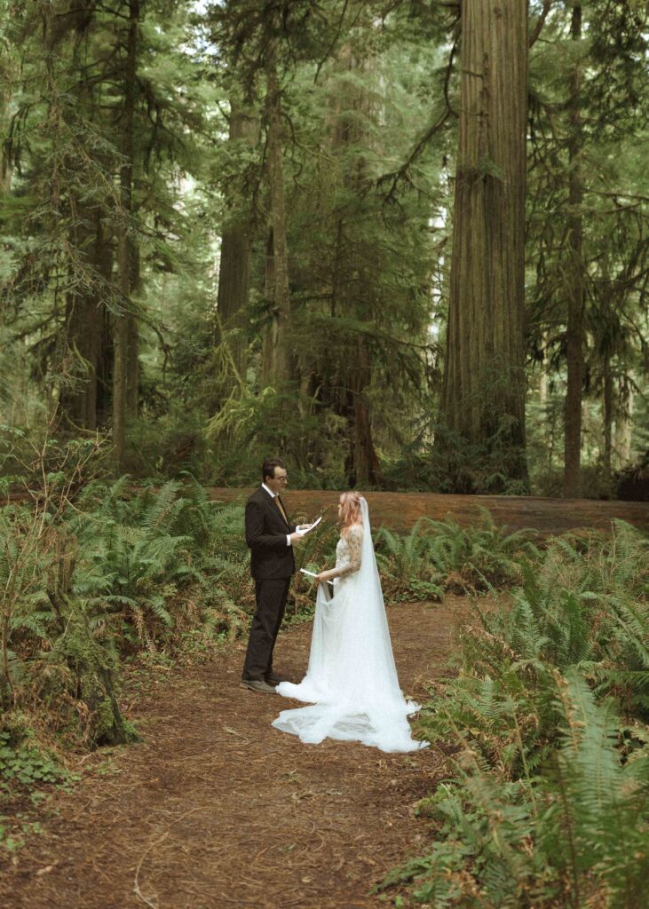 bride and groom reading vows for their redwoods wedding 