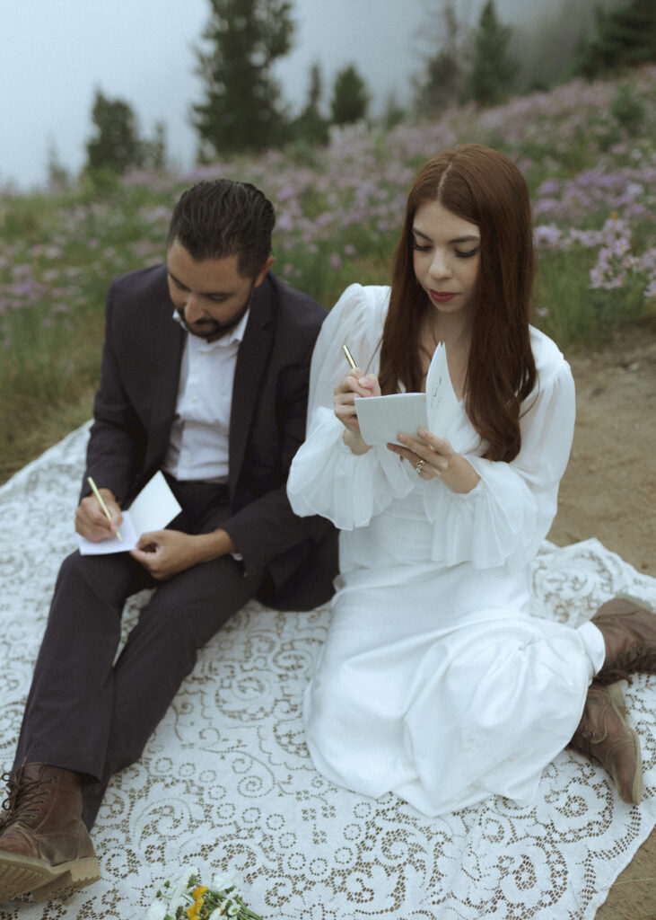 bride and groom writing vows for their mountain wedding 