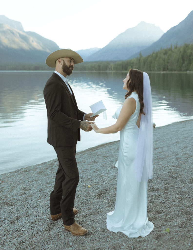 bride and groom reading their vows for their Lake McDonald Elopement