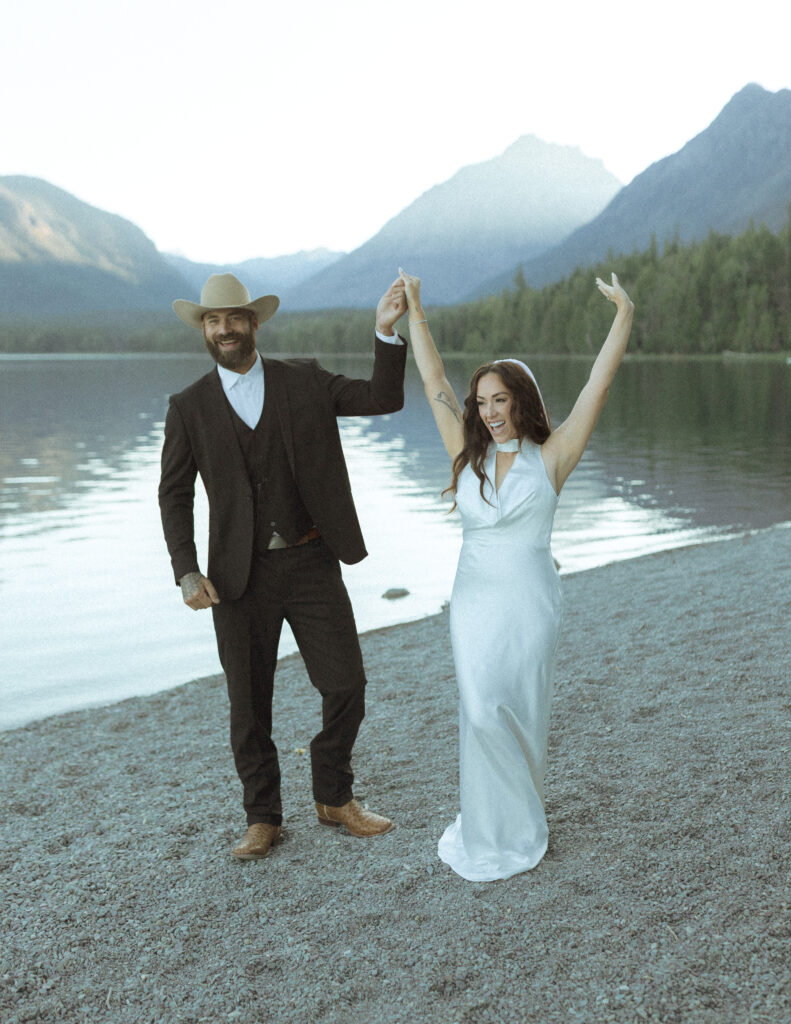 couple taking photos for their lake McDonald elopement