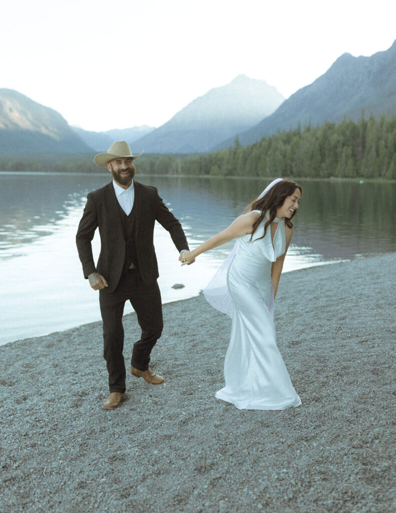 couple taking photos for their lake McDonald elopement