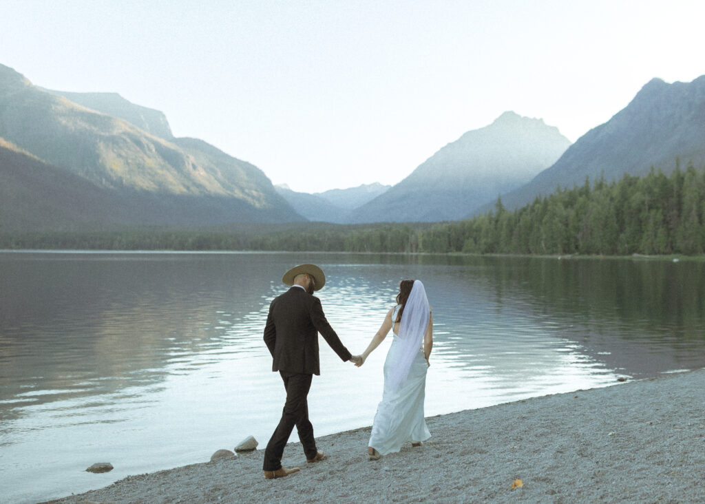 couple taking photos for their lake McDonald elopement