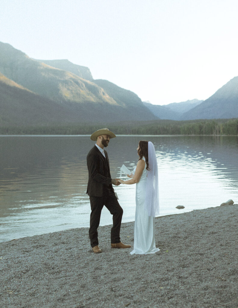 bride and groom reading their vows for their Lake McDonald Elopement
