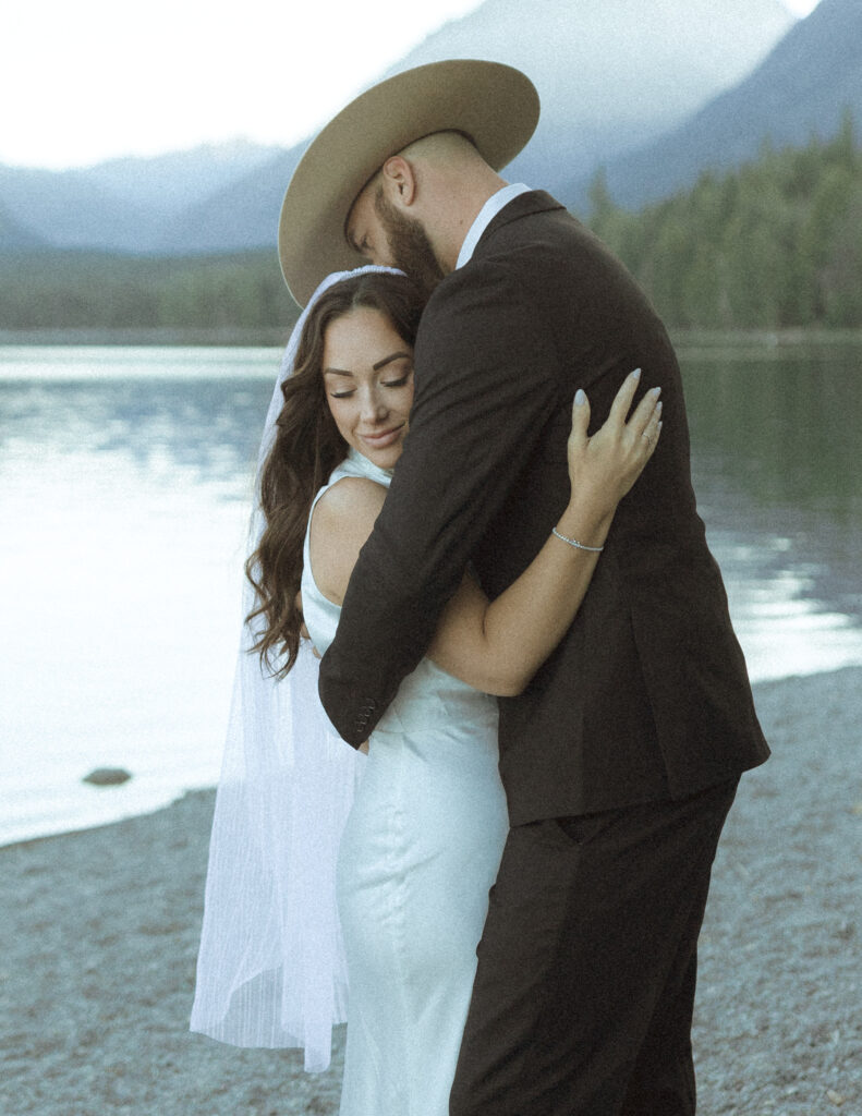 couple taking photos for their lake McDonald elopement