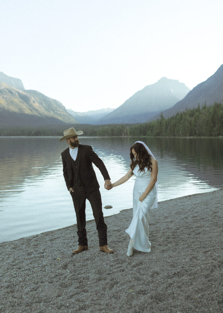 couple taking photos for their lake McDonald elopement