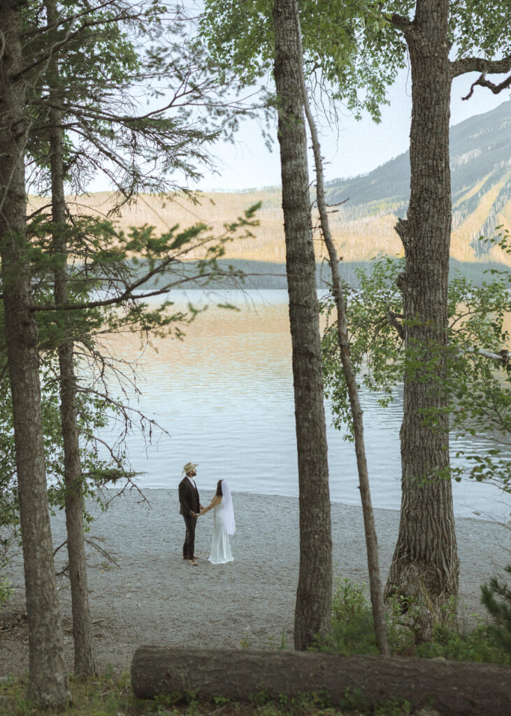 couple taking photos for their lake McDonald elopement