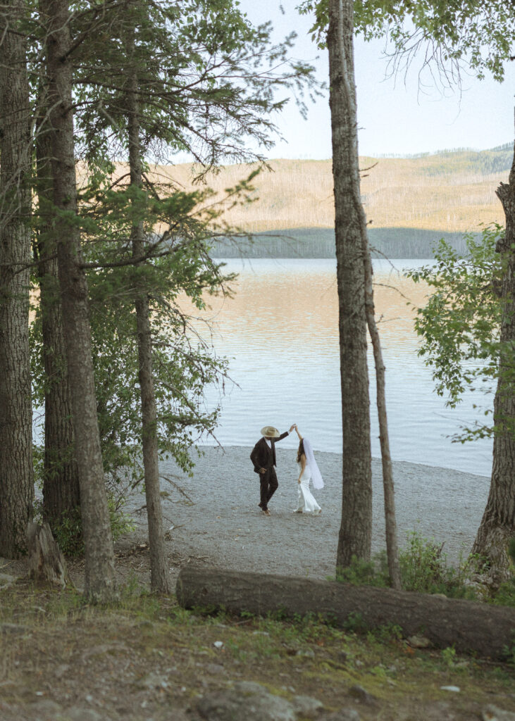 couple taking wedding photos at Lake McDonald