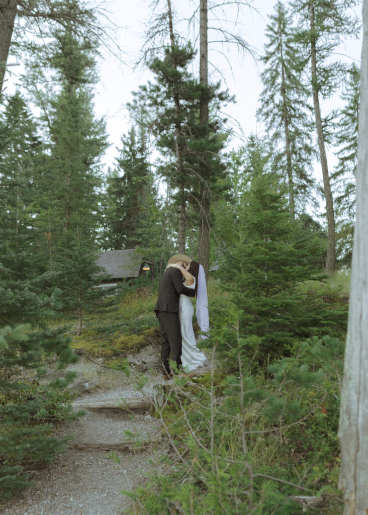 couple taking photos for their lake McDonald elopement