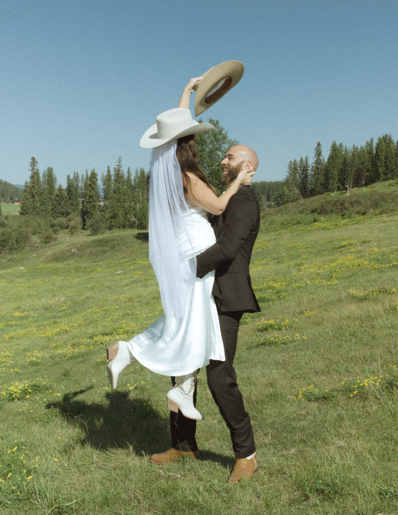 couple taking photos with horses after their lake McDonald elopement