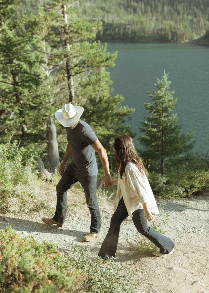 couple taking casual photos the day after their lake McDonald elopement