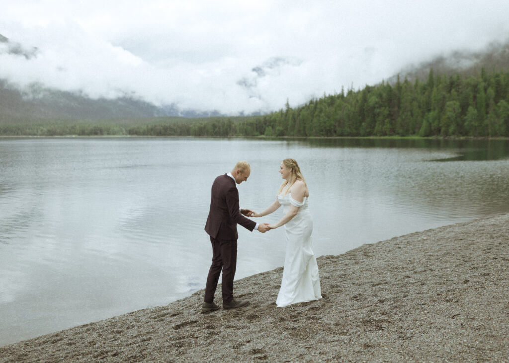 bride and groom taking photos after their lake McDonald Lodge Elopement