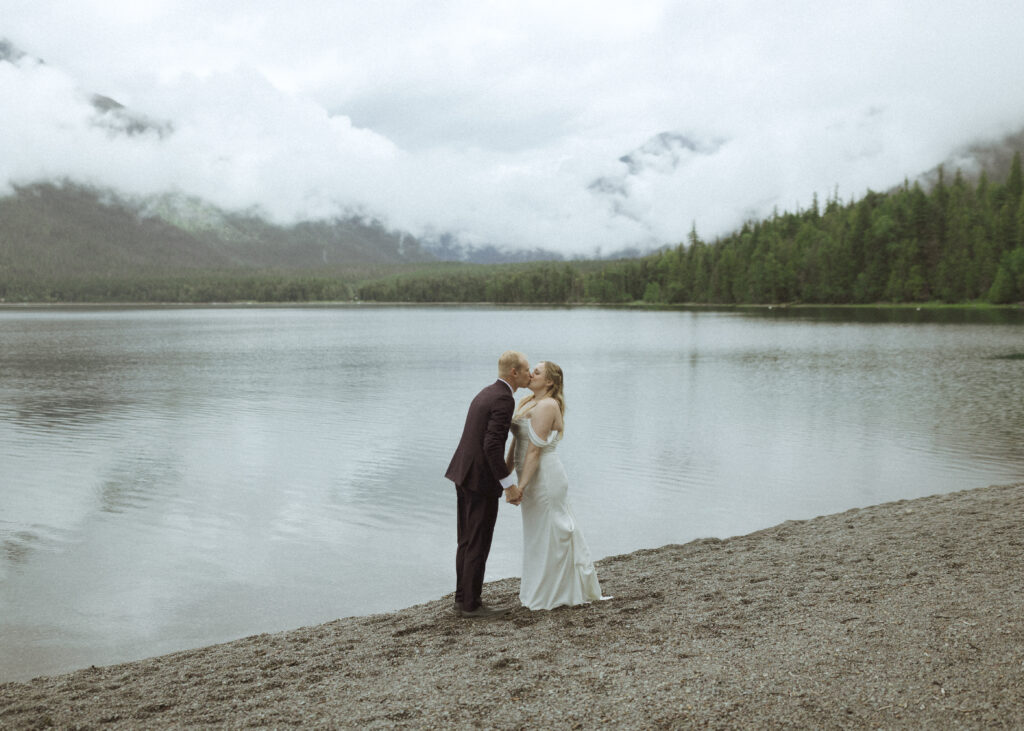 bride and groom taking photos after their lake McDonald Lodge Elopement