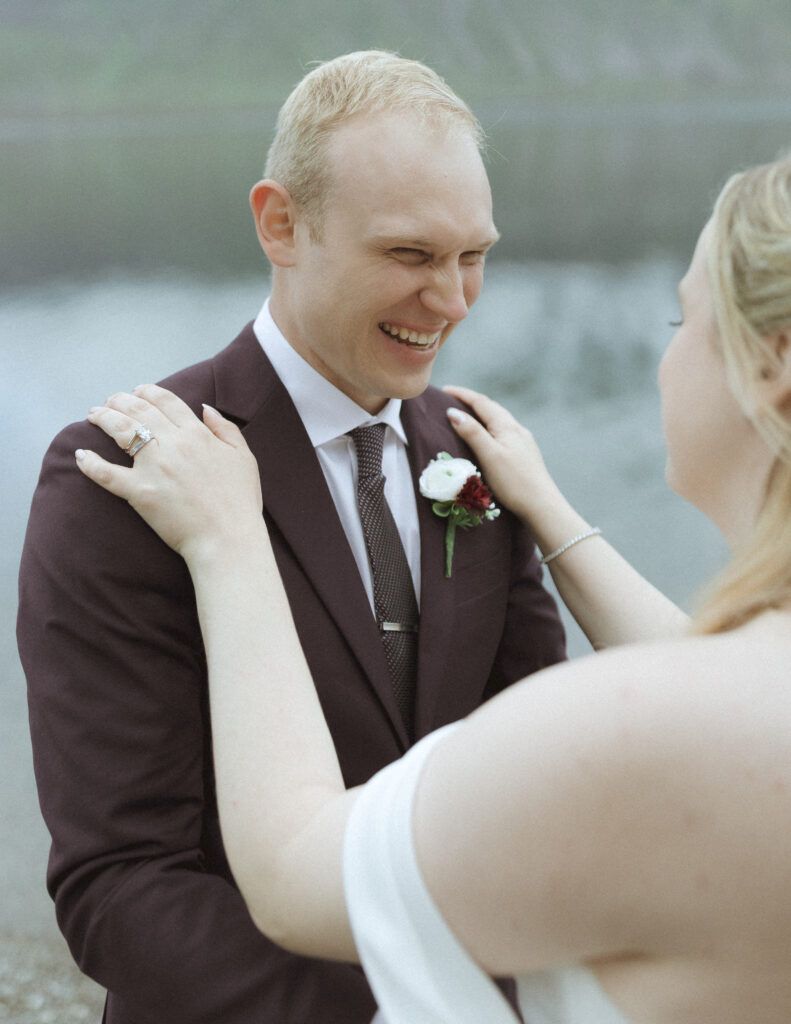 bride and groom taking photos after their lake McDonald Lodge Elopement