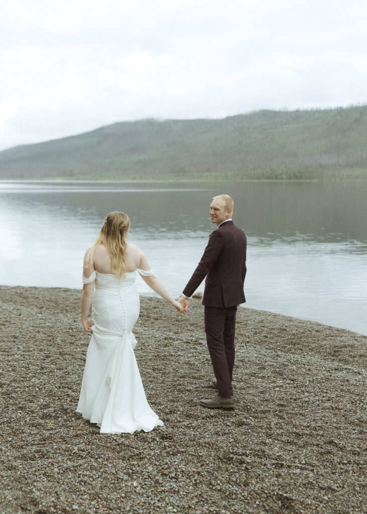 bride and groom taking photos after their lake McDonald Lodge Elopement