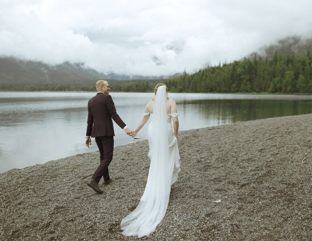 bride and groom taking photos after their lake McDonald Lodge Elopement