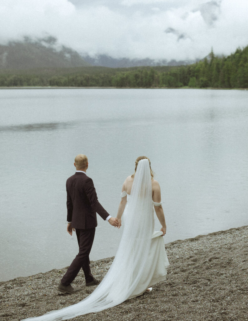 bride and groom taking photos after their lake McDonald Lodge Elopement