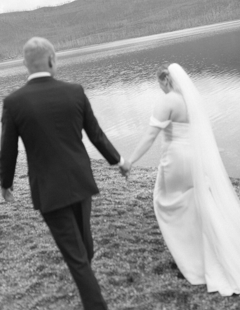bride and groom taking photos after their lake McDonald Lodge Elopement