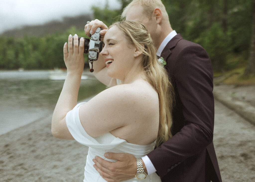 bride and groom taking photos after their lake McDonald Lodge Elopement