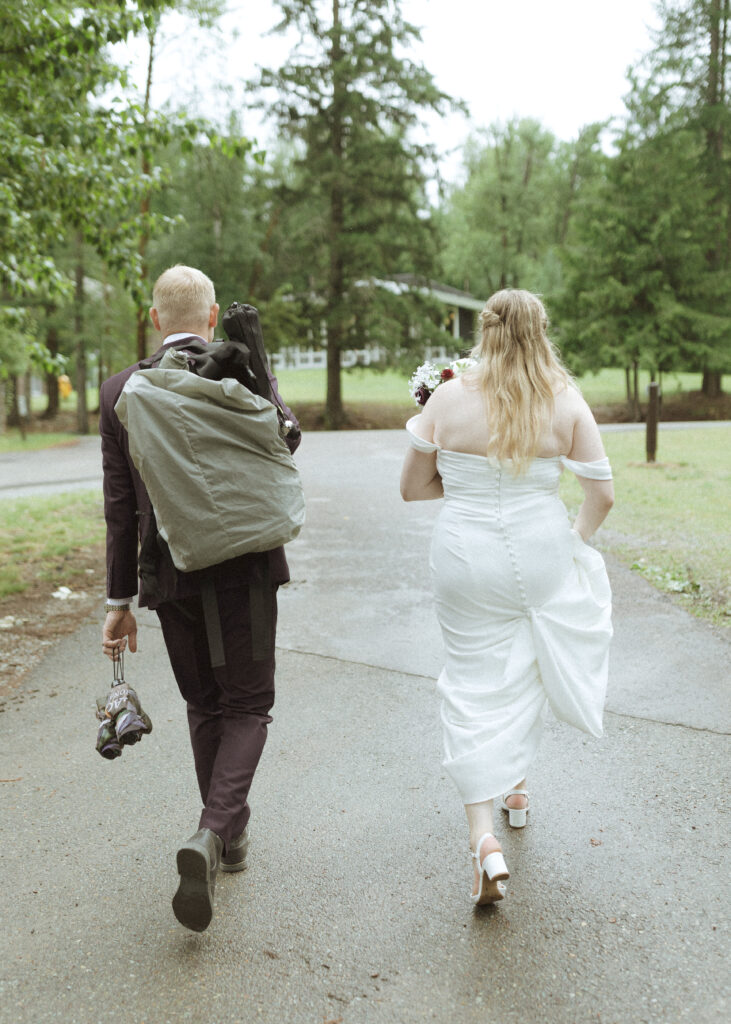 bride and groom taking photos after their lake McDonald Lodge Elopement
