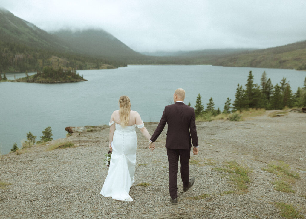 bride and groom taking photos after their lake McDonald Lodge Elopement