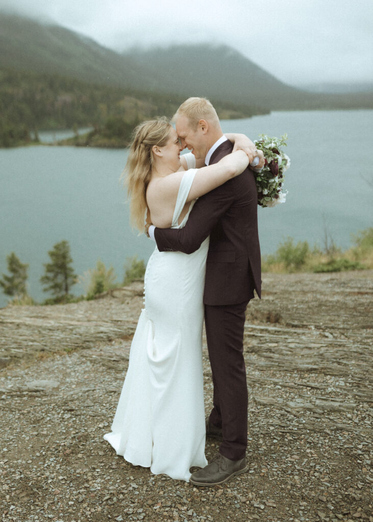 bride and groom taking photos after their lake McDonald Lodge Elopement