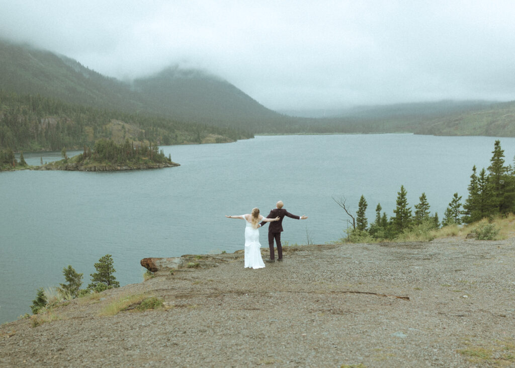 bride and groom taking photos after their lake McDonald Lodge Elopement