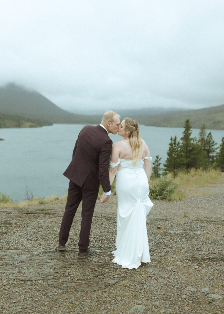 bride and groom taking photos after their lake McDonald Lodge Elopement