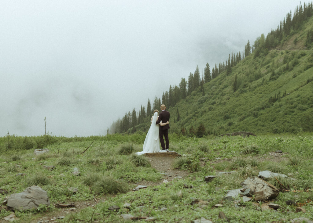 bride and groom taking photos after their lake McDonald Lodge Elopement