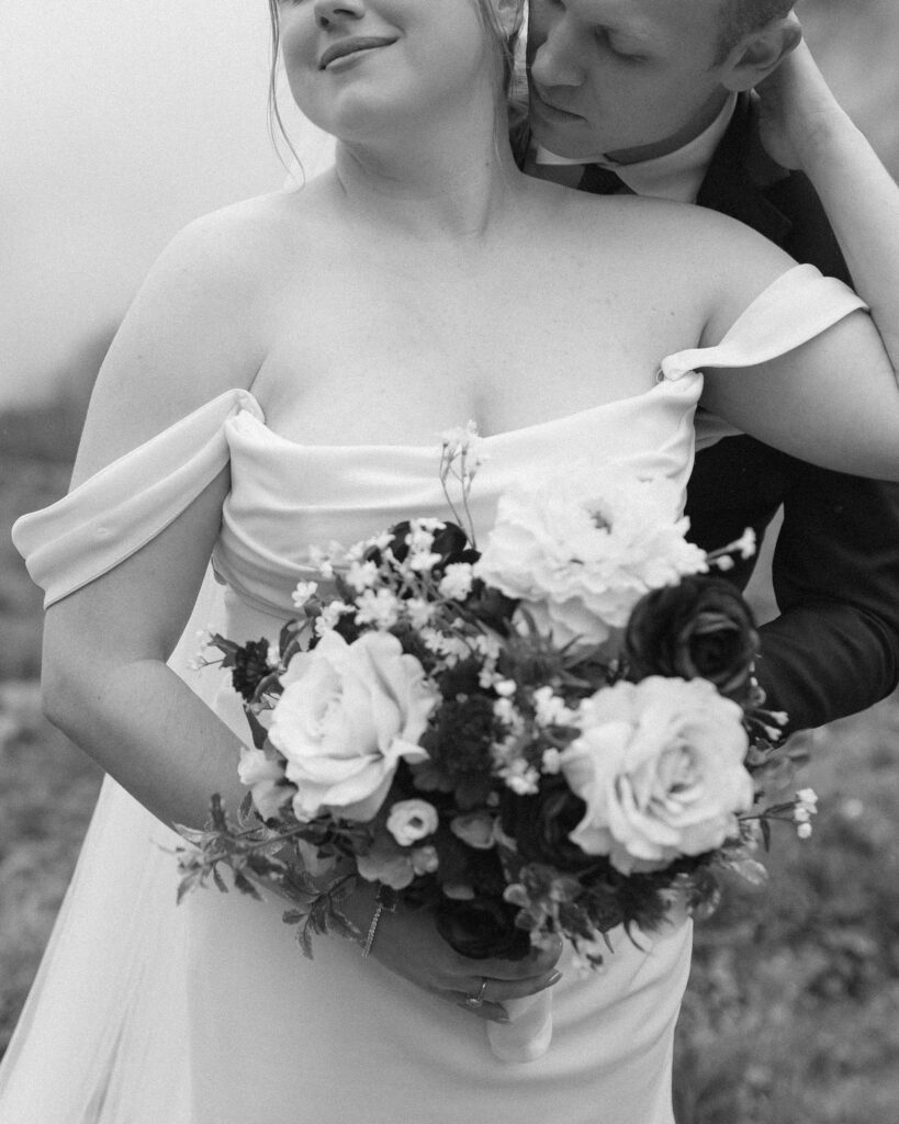 bride and groom taking photos after their lake McDonald Lodge Elopement