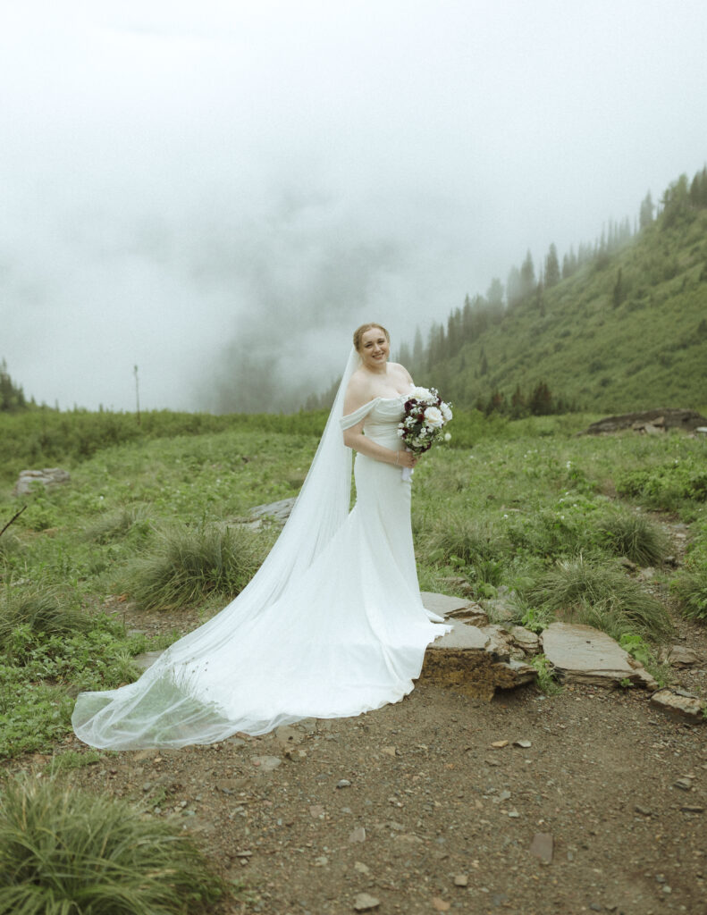 bride and groom taking photos after their lake McDonald Lodge Elopement