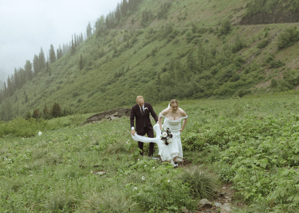 bride and groom taking photos after their lake McDonald Lodge Elopement