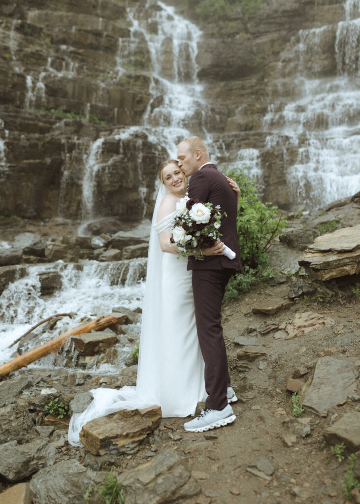 bride and groom taking photos after their lake McDonald Lodge Elopement