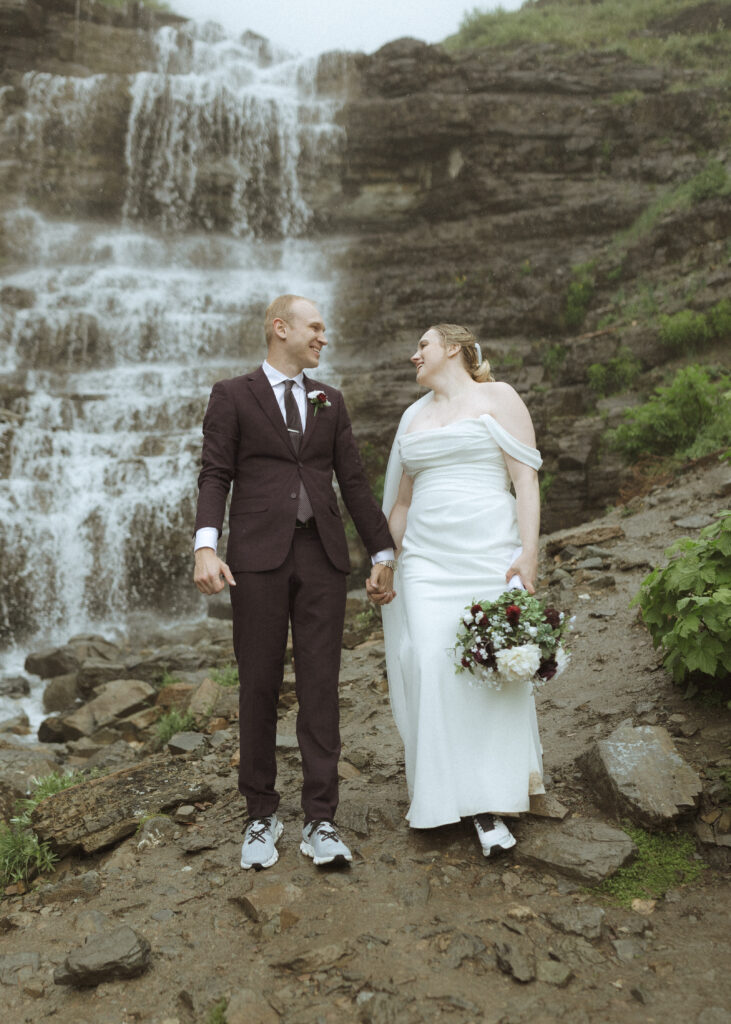 bride and groom taking photos after their lake McDonald Lodge Elopement