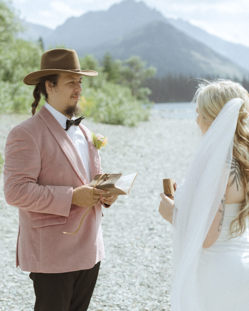 couple reading their vows for their logan pass elopement