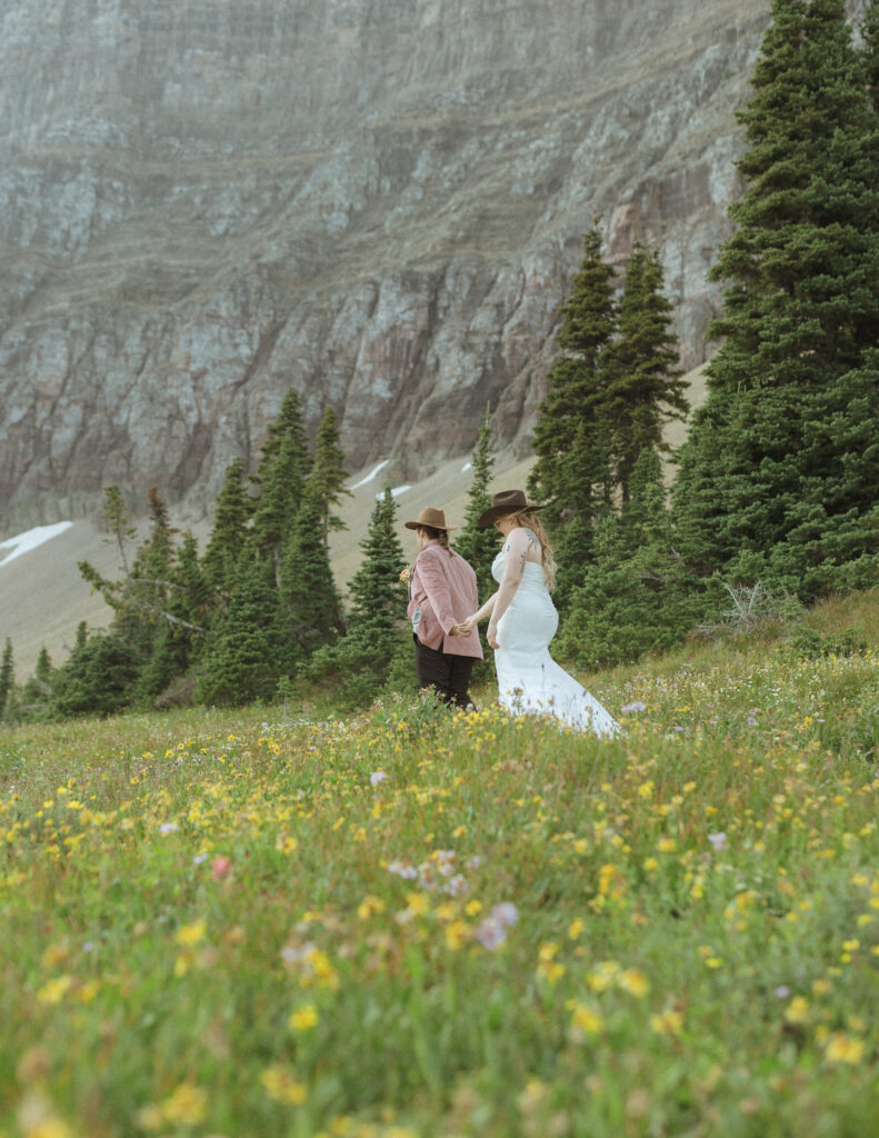 couple taking their wedding photos for their logan pass elopement