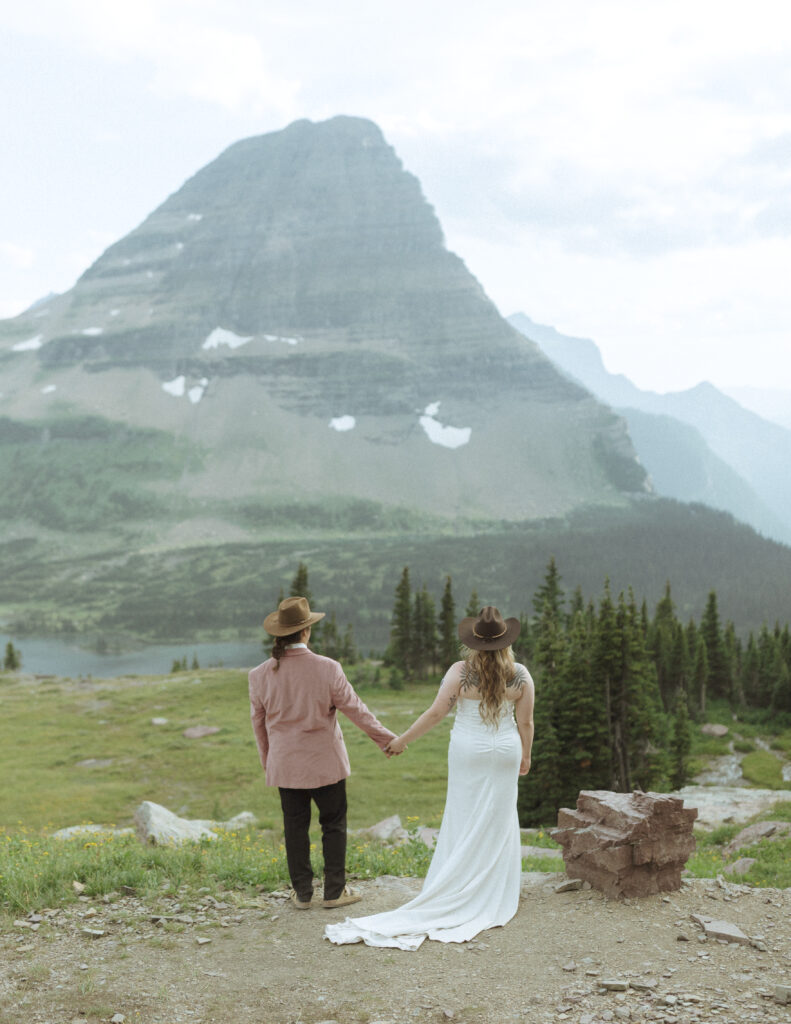 couple taking their wedding photos for their logan pass elopement