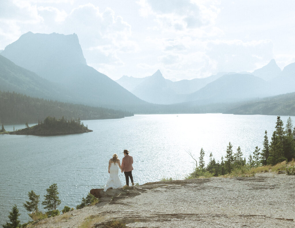 bride and groom at a lake in glacier national park