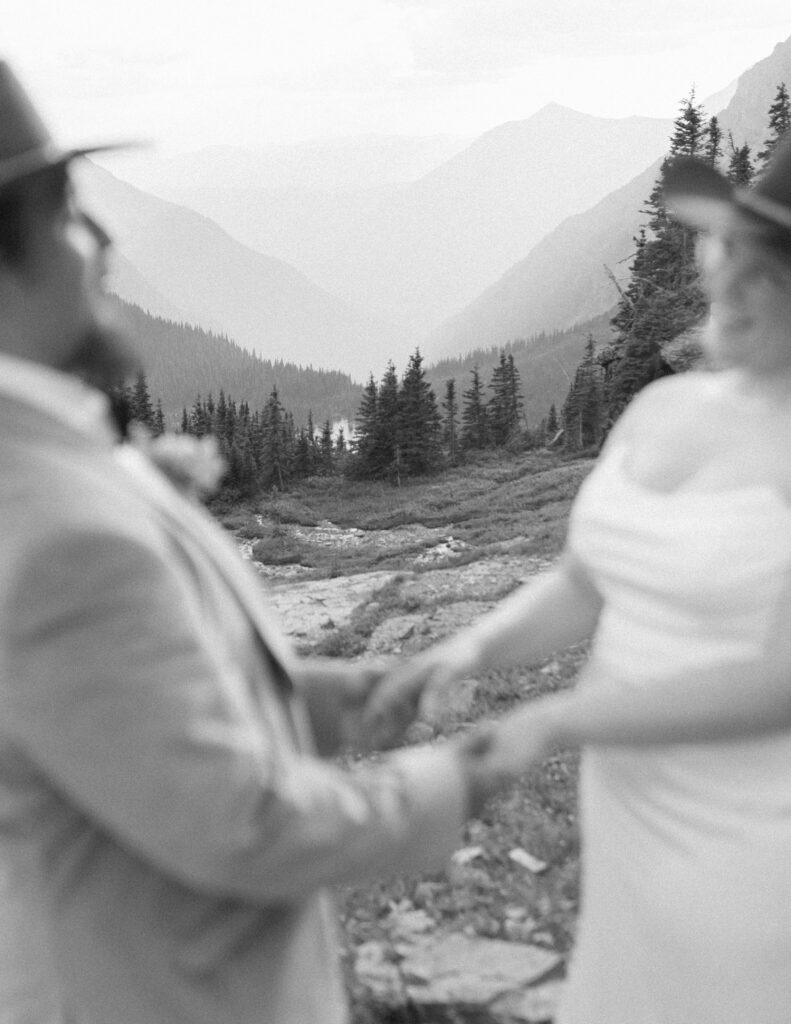 couple taking their wedding photos for their logan pass elopement