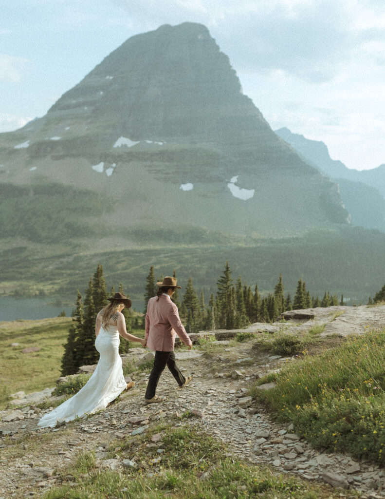 couple taking their wedding photos for their logan pass elopement