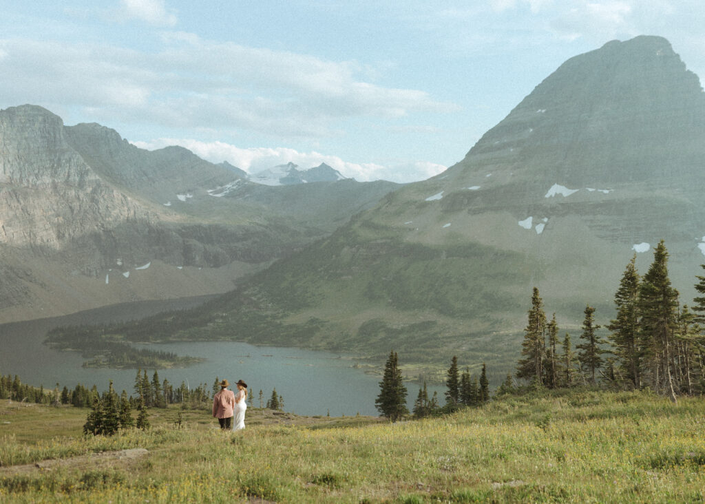 couple taking their wedding photos for their logan pass elopement
