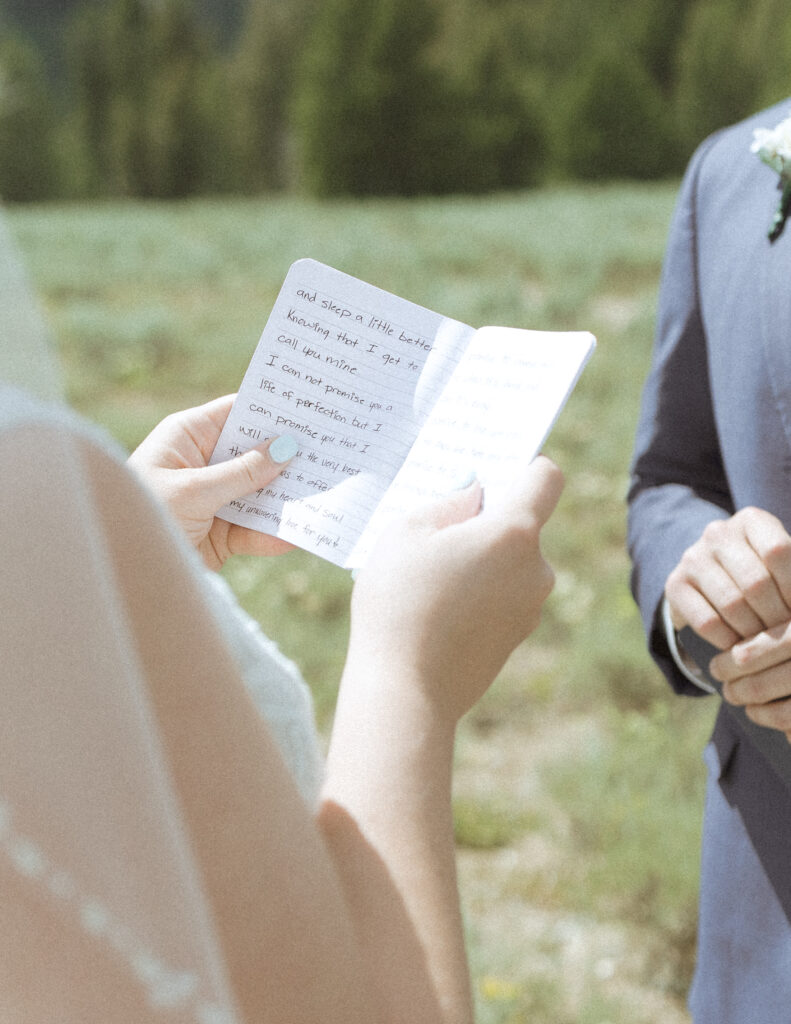 bride and groom reading their vows privately before their mountain view turnout wedding