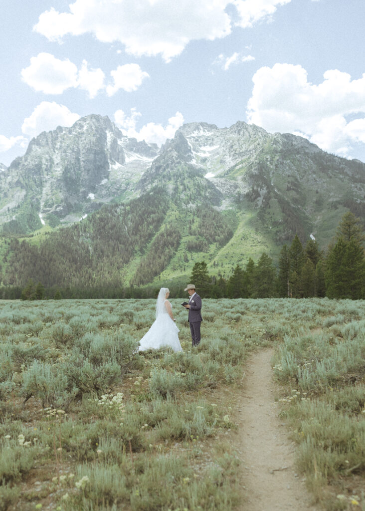bride and groom reading their vows privately before their mountain view turnout wedding