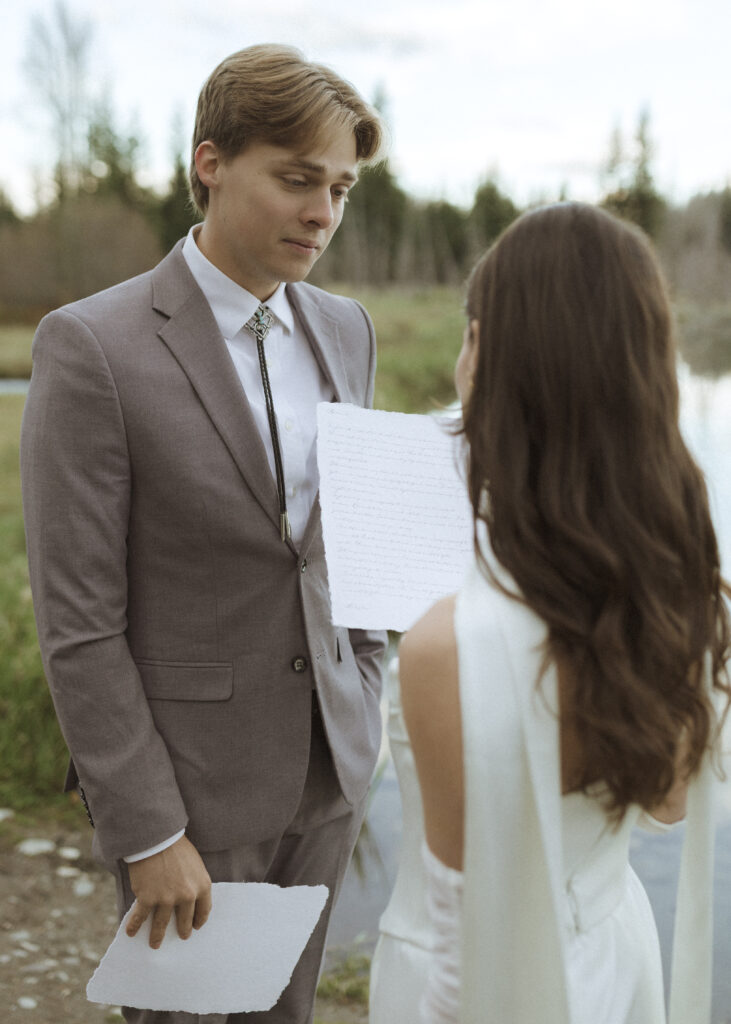 couple reading their vows at their Schwabacher Landing Elopement